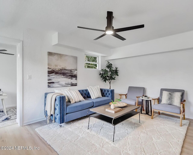 living room with hardwood / wood-style flooring and ceiling fan