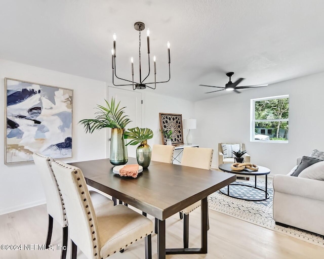 dining space featuring ceiling fan and light wood-type flooring