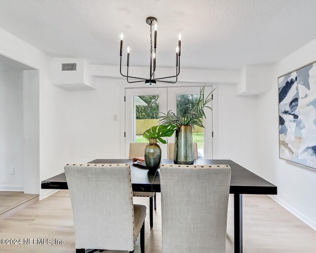 dining room featuring an inviting chandelier and light hardwood / wood-style floors