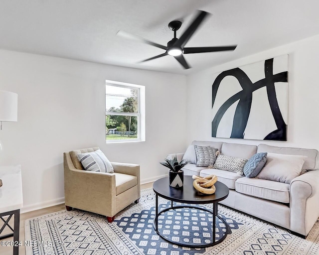 living room with light hardwood / wood-style floors and ceiling fan