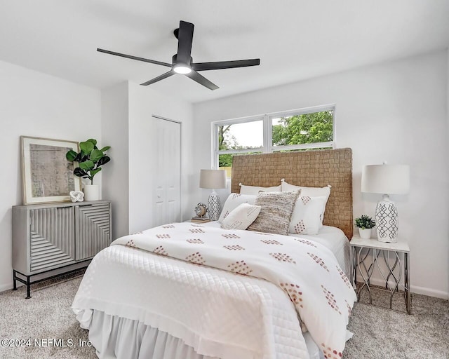 bedroom with light carpet, ceiling fan, and a closet