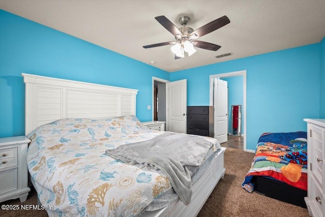 bedroom with dark colored carpet and ceiling fan