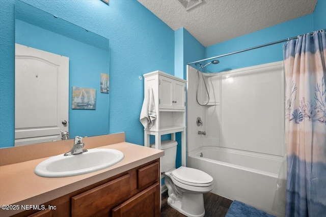 full bathroom featuring hardwood / wood-style floors, vanity, toilet, shower / bath combo, and a textured ceiling