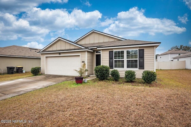 view of front of home with a garage and a front lawn