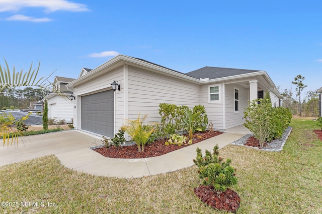 view of front of home with a garage and a front yard