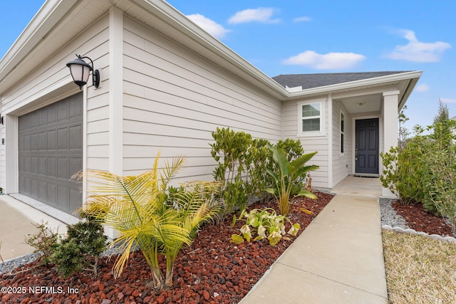 view of exterior entry featuring a garage