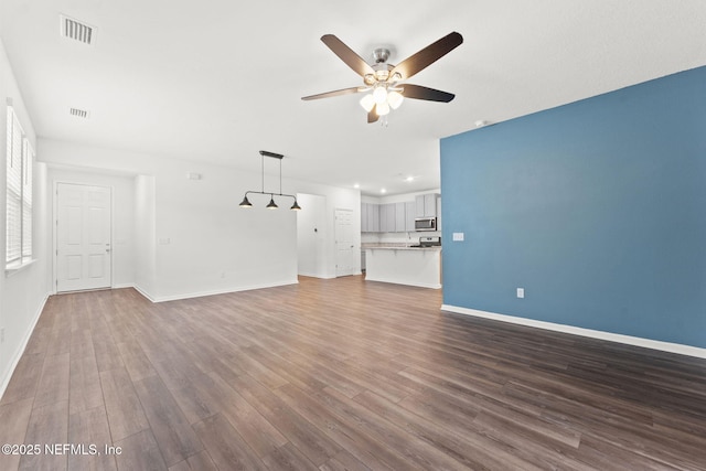 unfurnished living room featuring ceiling fan and wood-type flooring