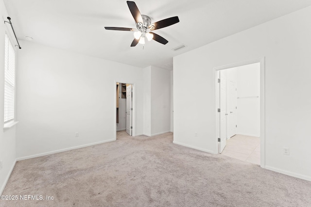 spare room with light carpet and ceiling fan