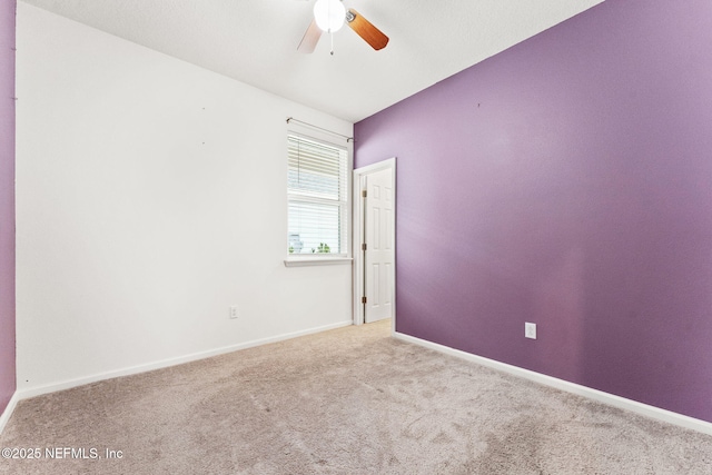 unfurnished room featuring ceiling fan and light colored carpet