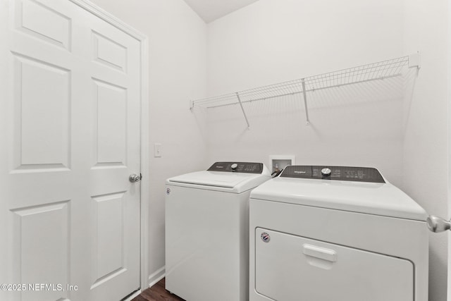 laundry area featuring washing machine and clothes dryer and dark hardwood / wood-style flooring