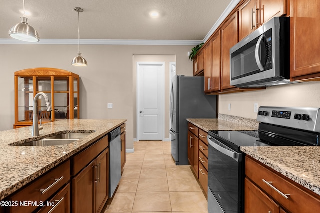 kitchen featuring sink, hanging light fixtures, ornamental molding, light stone counters, and stainless steel appliances