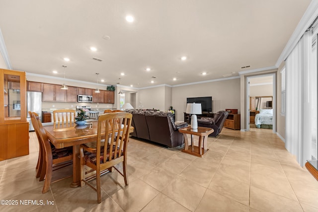 dining area featuring ornamental molding and light tile patterned floors