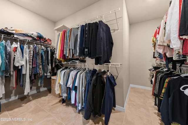 walk in closet featuring light tile patterned flooring