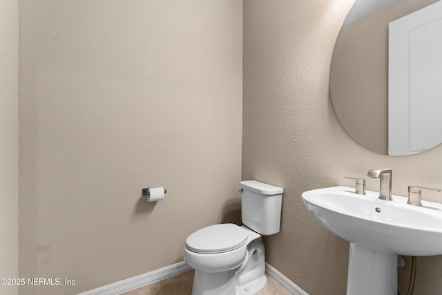 bathroom featuring sink and toilet