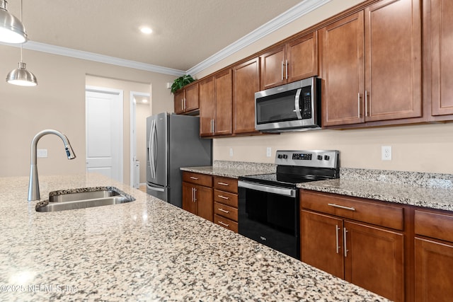 kitchen with sink, ornamental molding, pendant lighting, stainless steel appliances, and light stone countertops