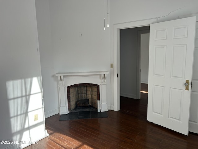 unfurnished living room with dark hardwood / wood-style floors