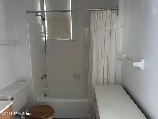 full bathroom with vanity, toilet, and shower / bath combo with shower curtain