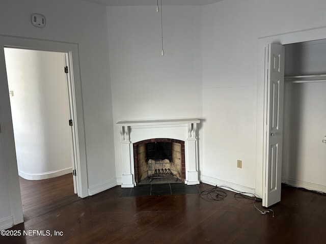 unfurnished living room featuring dark wood-type flooring