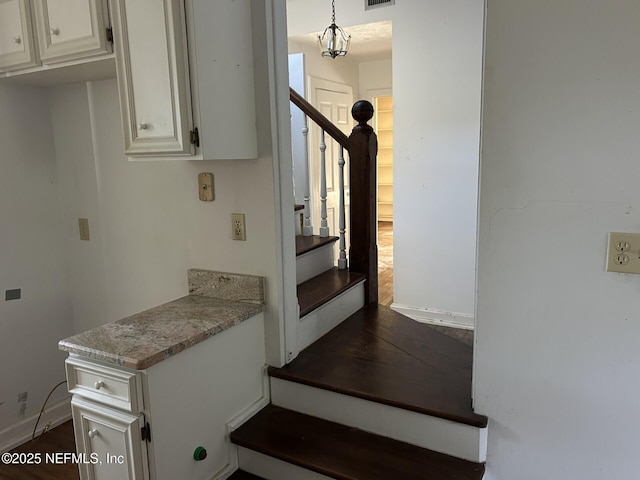 staircase with hardwood / wood-style flooring