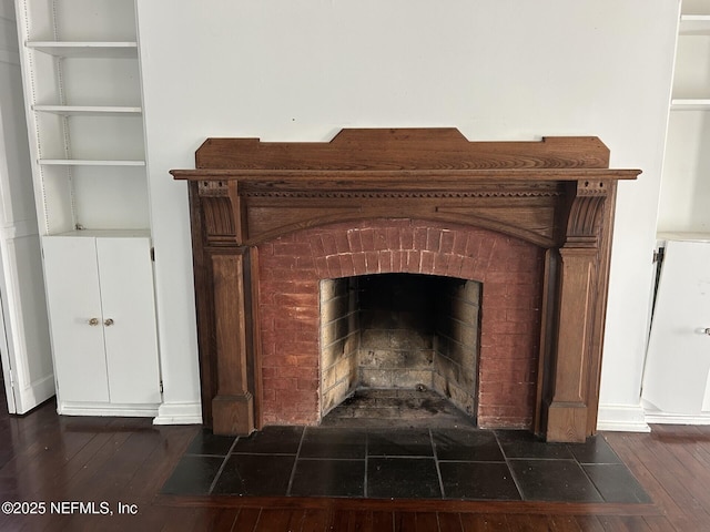 room details with hardwood / wood-style floors and a brick fireplace