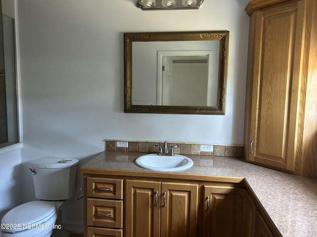 bathroom featuring vanity and toilet