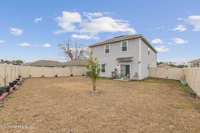 rear view of house with a patio and a lawn