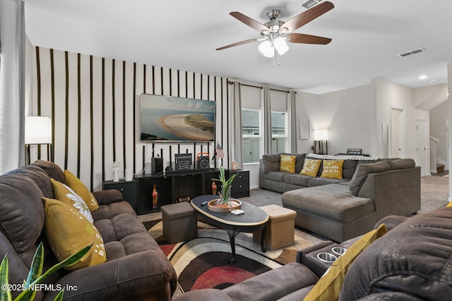 living room featuring carpet floors and ceiling fan