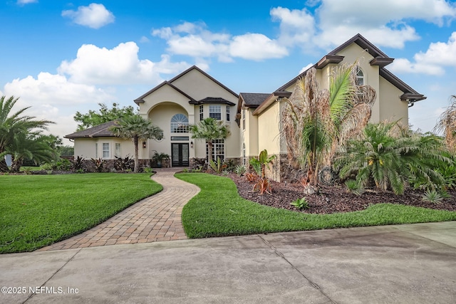 view of front of house featuring a front lawn and french doors