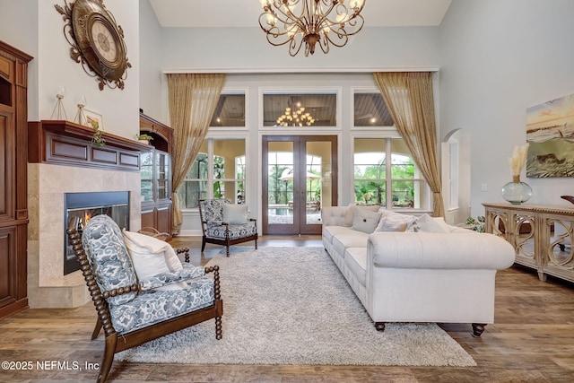 living room with a high ceiling, hardwood / wood-style floors, and a fireplace