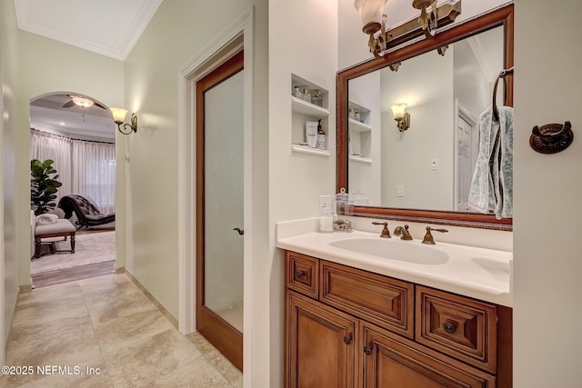 bathroom with crown molding, vanity, and an enclosed shower