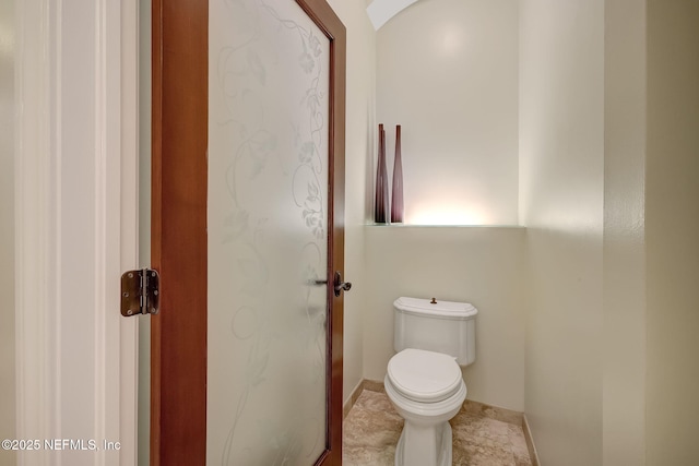 bathroom featuring tile patterned flooring and toilet