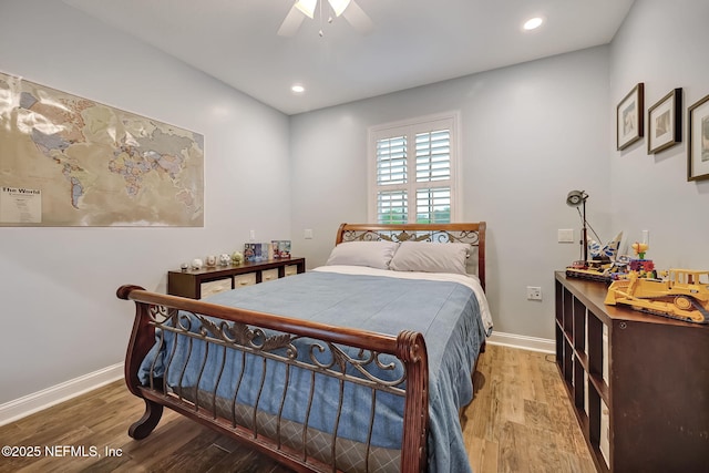 bedroom with ceiling fan and hardwood / wood-style floors