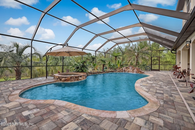 view of pool featuring an in ground hot tub, a patio, and glass enclosure