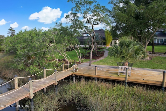 view of dock with a yard and a deck