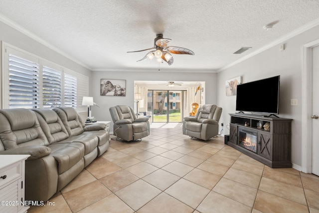 living room with light tile patterned floors, crown molding, and a textured ceiling