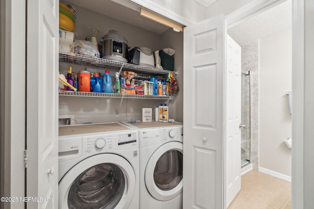 laundry room with light tile patterned floors and washing machine and dryer