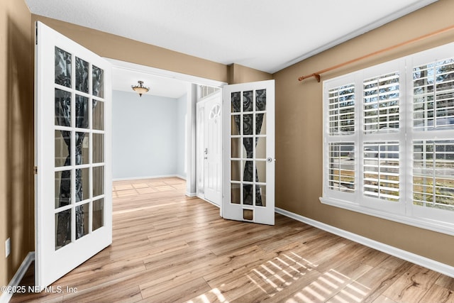 unfurnished room with french doors and wood-type flooring