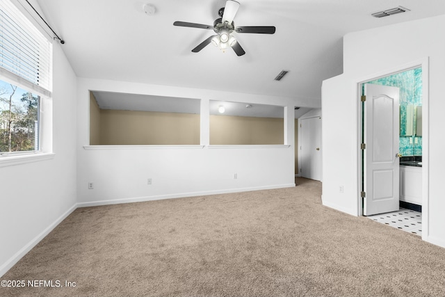 empty room featuring light colored carpet and ceiling fan