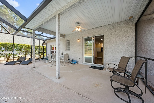 view of patio featuring a lanai and ceiling fan