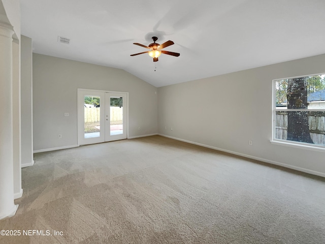 spare room with french doors, light colored carpet, lofted ceiling, and ceiling fan