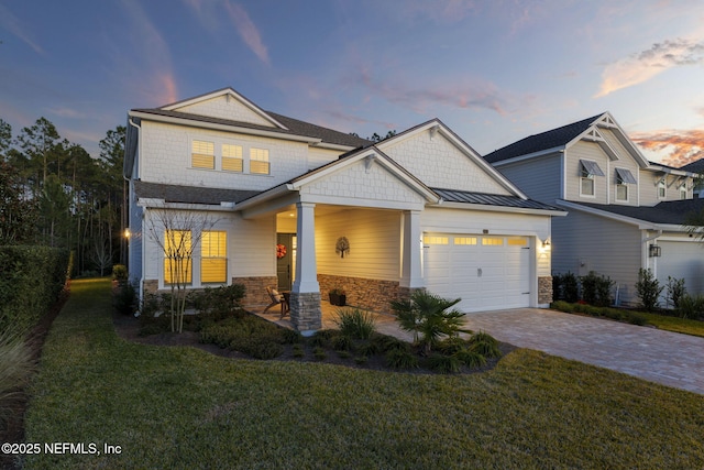 craftsman house featuring a garage and a yard