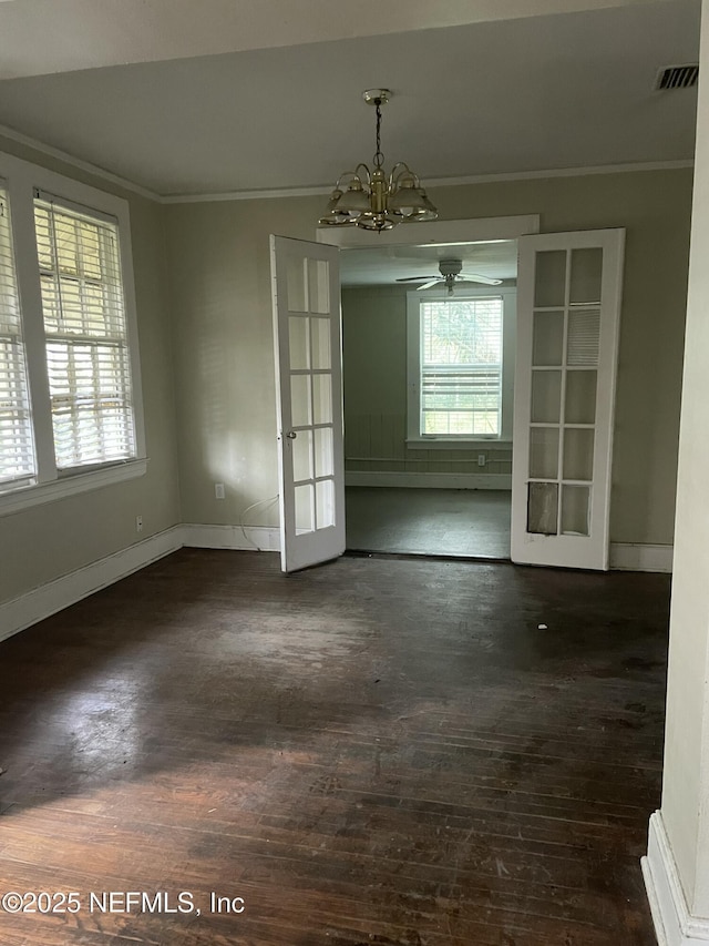 unfurnished dining area with french doors, ornamental molding, dark wood-type flooring, and plenty of natural light