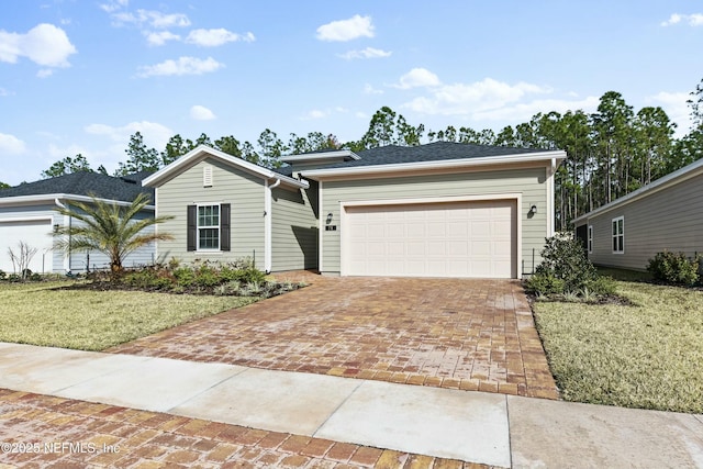 ranch-style house with a garage and a front lawn