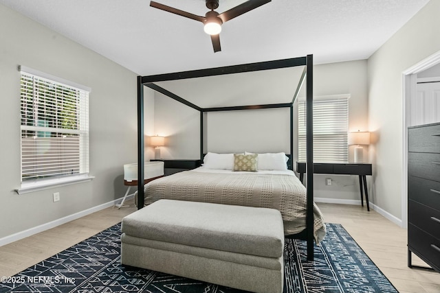 bedroom with ceiling fan and light wood-type flooring