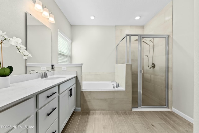 bathroom featuring vanity and shower with separate bathtub