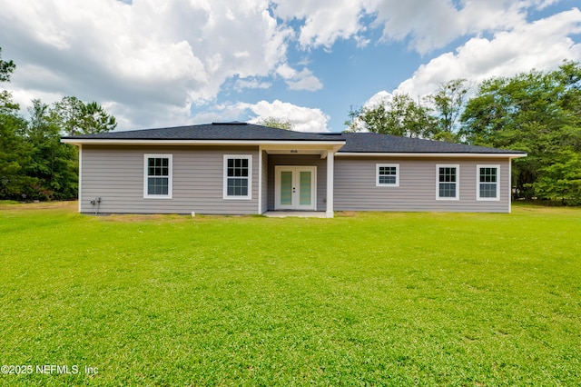 back of house featuring a lawn and french doors