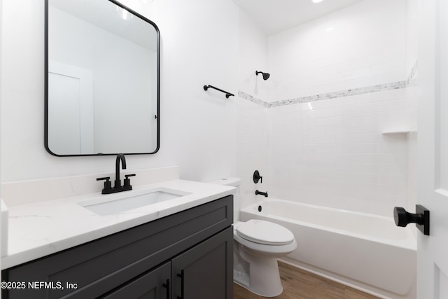 full bathroom featuring bathing tub / shower combination, hardwood / wood-style floors, vanity, and toilet