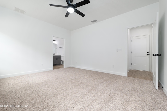 carpeted spare room with ceiling fan