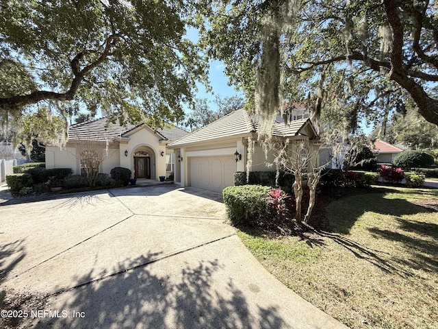 view of front of house with a garage and a front yard