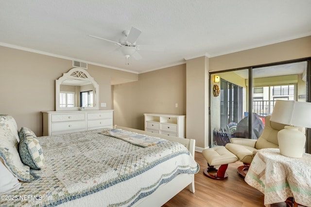 bedroom featuring access to exterior, wood-type flooring, and ornamental molding